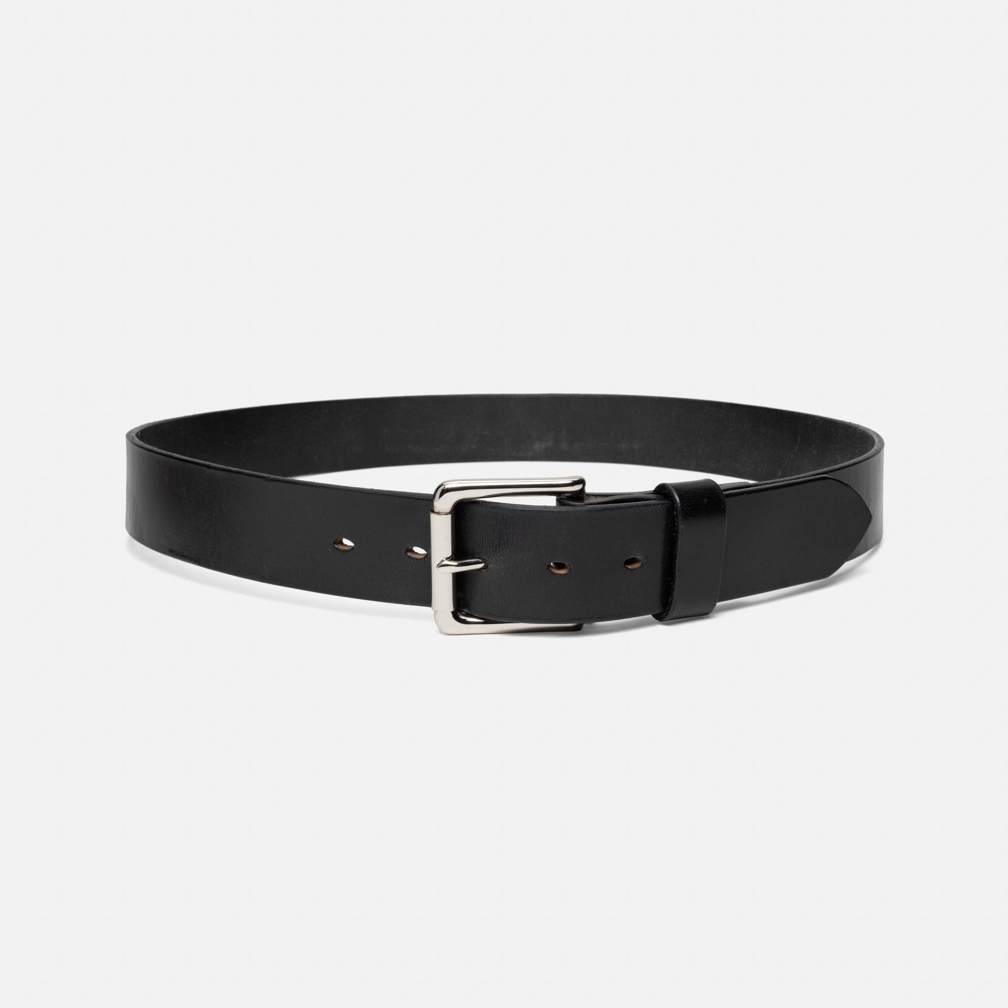 Black leather belt with a silver buckle on a light gray background